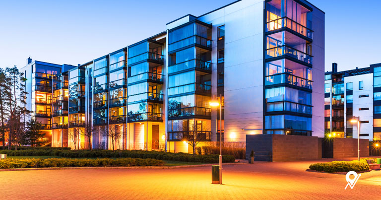 Modern commercial buildings lit up at dusk